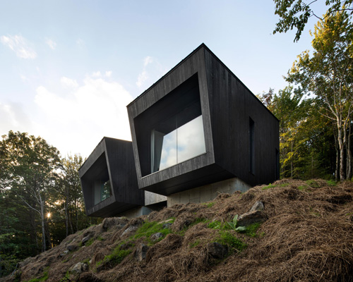 naturehumaine's la binocle cabin combines two angular volumes clad in burnt wood