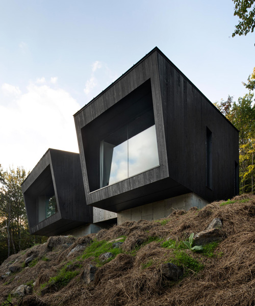 naturehumaine's la binocle cabin combines two angular volumes clad in burnt wood