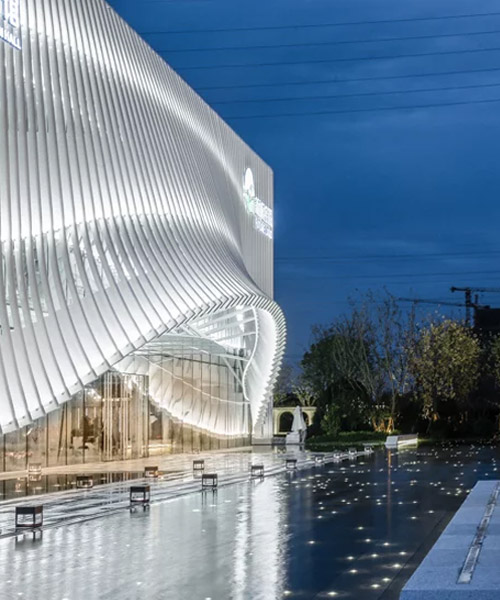 lacime architects cover exhibition hall with undulating façade in suzhou, china