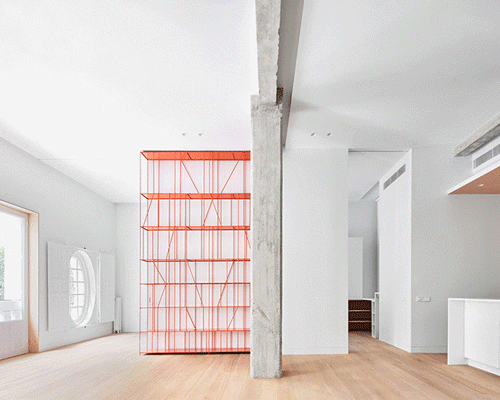 lucas y hernández-gil completes a madrid apartment with a coral-painted metal shelf