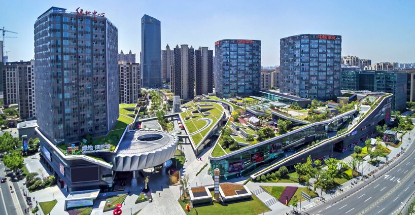 the greenland center by nikken sekkei forms shanghai's largest urban park