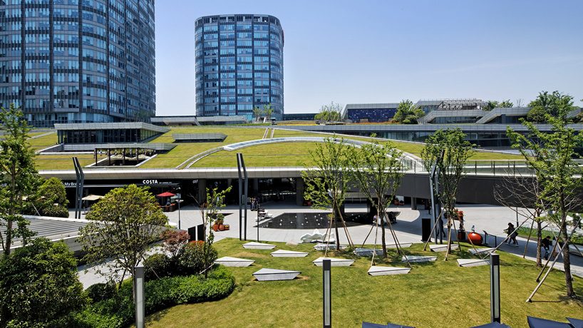 the greenland center by nikken sekkei forms shanghai's largest urban park