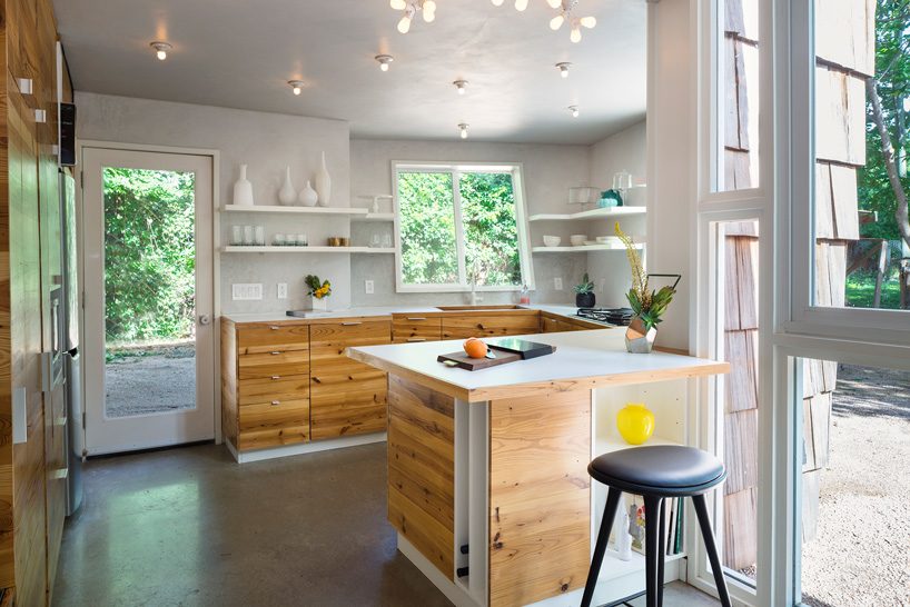 studio 512 clads the angled walls of this texas guesthouse in reclaimed cedar shakes