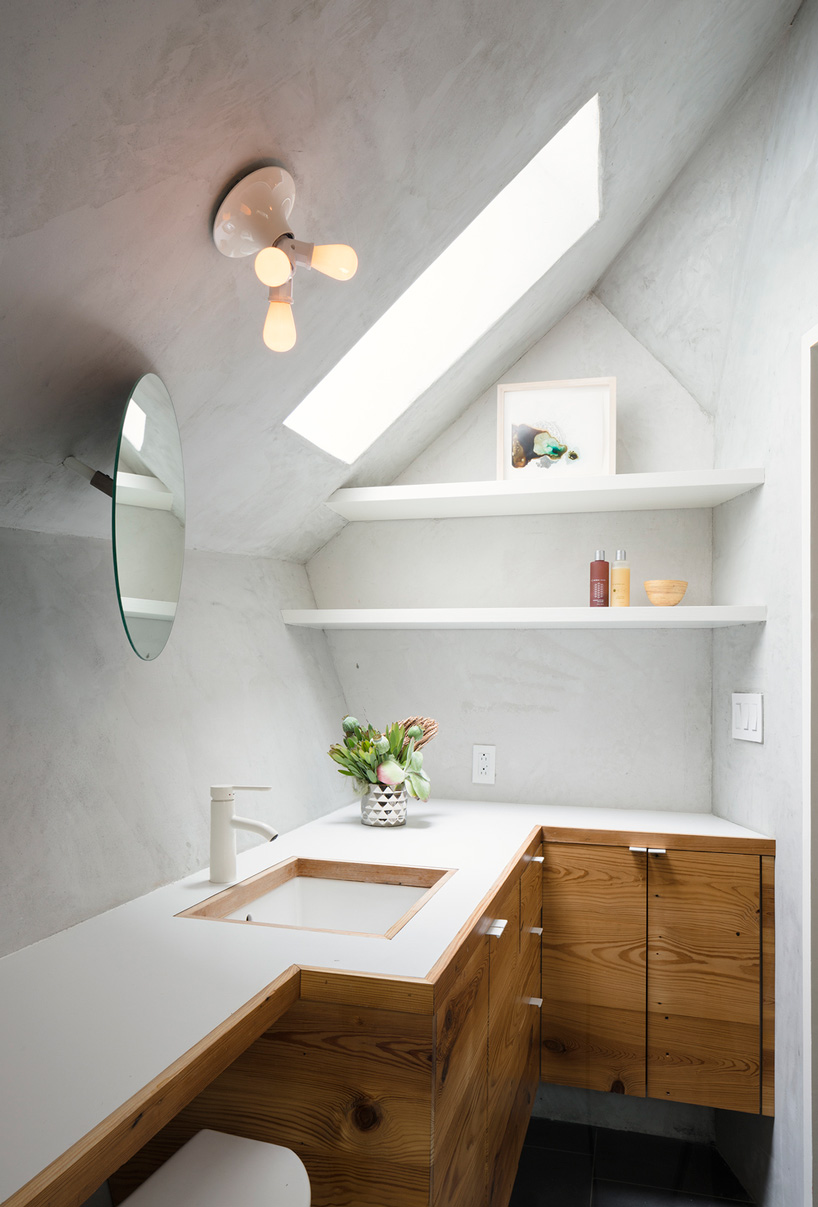 studio 512 clads the angled walls of this texas guesthouse in reclaimed cedar shakes