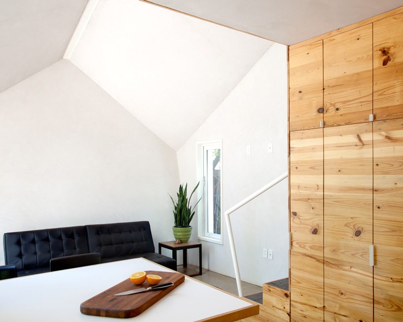 studio 512 clads the angled walls of this texas guesthouse in reclaimed cedar shakes