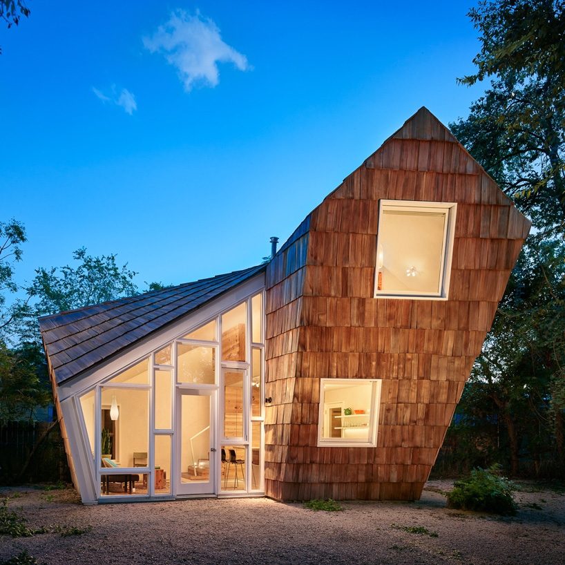 studio 512 clads the angled walls of this texas guesthouse in reclaimed cedar shakes