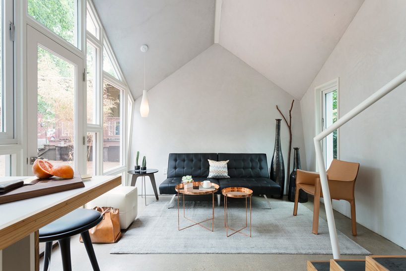 studio 512 clads the angled walls of this texas guesthouse in reclaimed cedar shakes