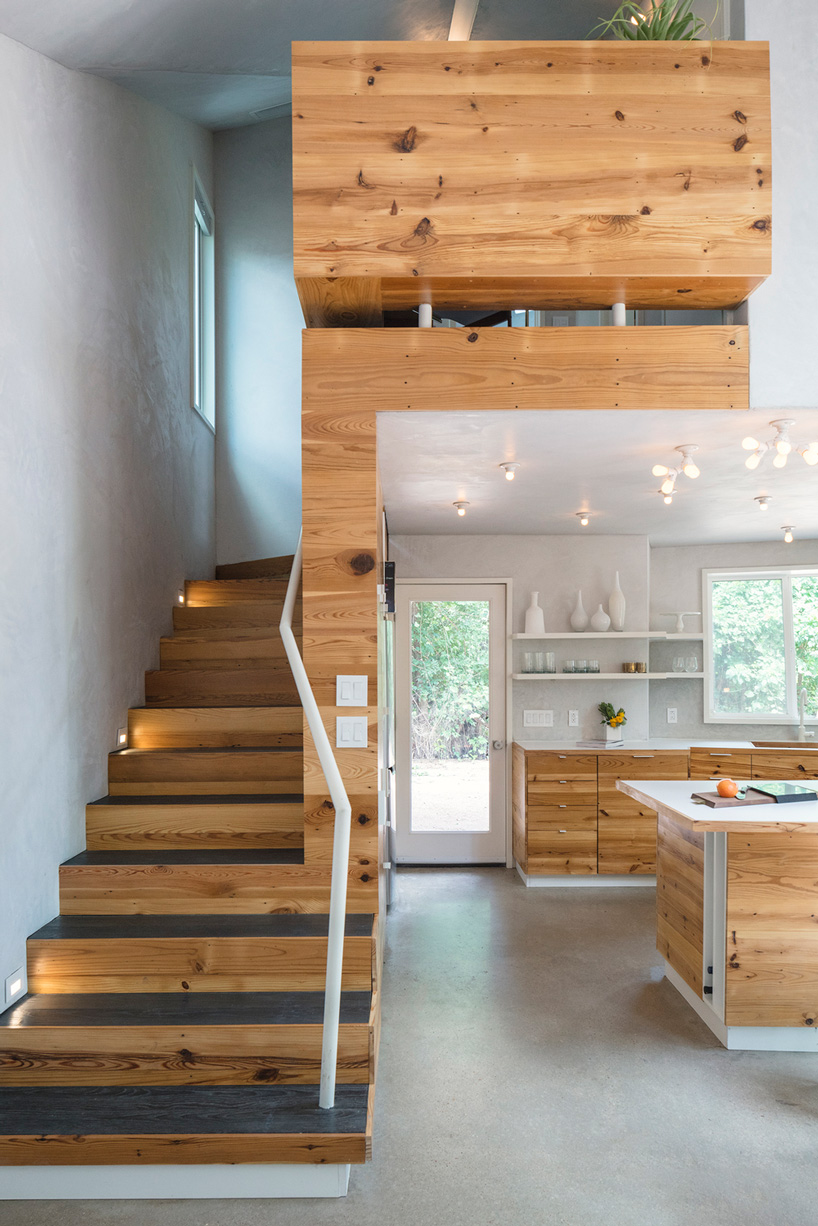 studio 512 clads the angled walls of this texas guesthouse in reclaimed cedar shakes