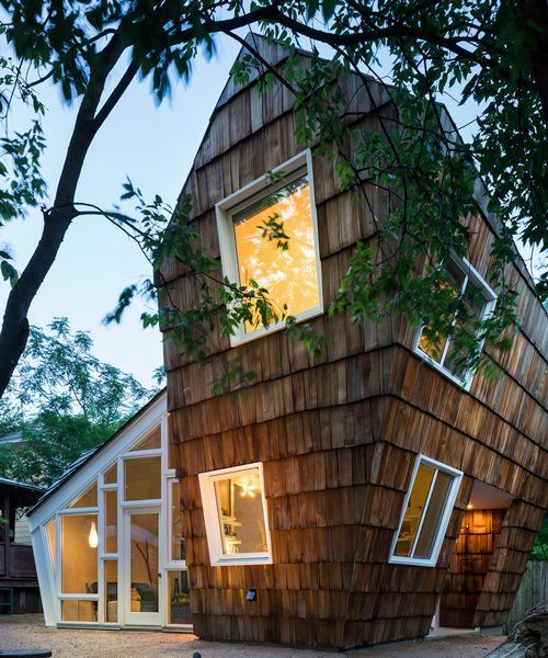 studio 512 clads the angled walls of this texas guesthouse in reclaimed cedar shakes