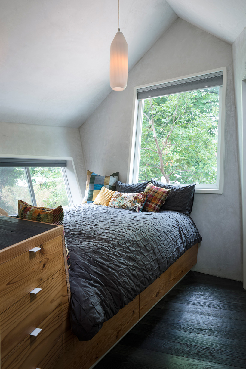 studio 512 clads the angled walls of this texas guesthouse in reclaimed cedar shakes