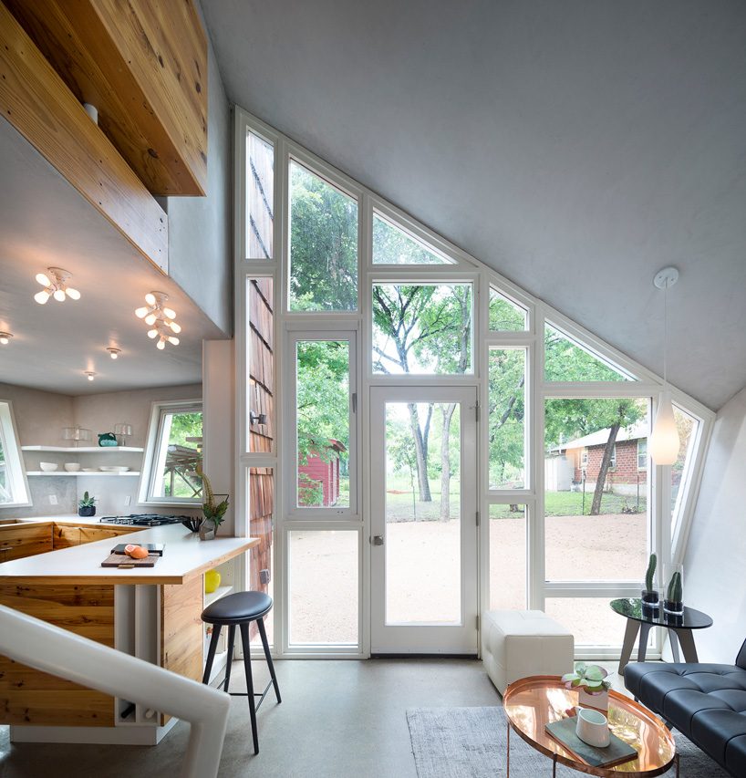 studio 512 clads the angled walls of this texas guesthouse in reclaimed cedar shakes
