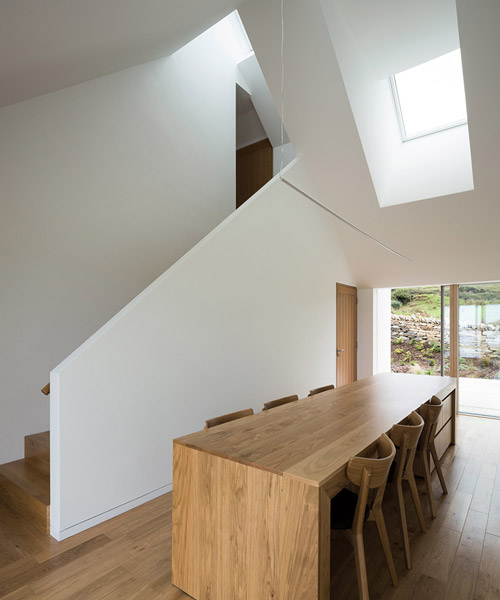 DUA completes cladach house with simple interiors and deep pitched roof in ireland