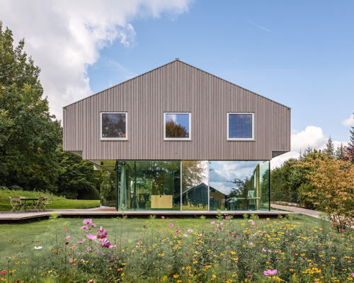 HHF architects' house H floats above the terrain using glass and reflective materials