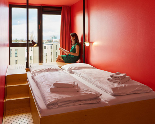 kinzo creates industrial chic meets maritime feel for container hostel in germany
