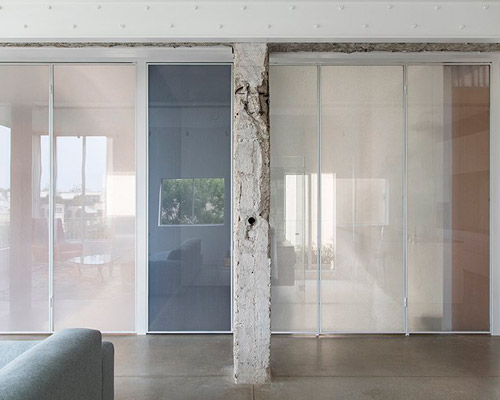 sliding dividers easily turn this tel aviv apartment into an open space