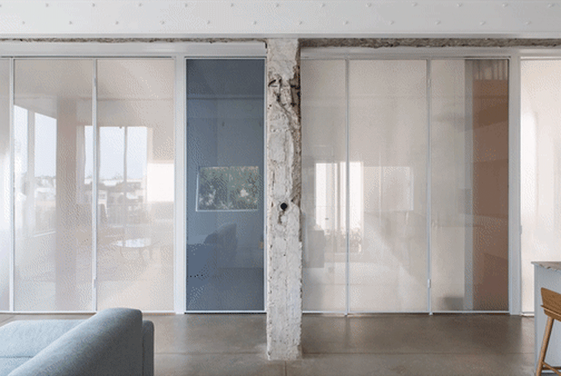 sliding dividers easily turn this tel aviv apartment into an open space