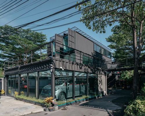 archimontage stacks shipping containers to form 'carcare' center in bangkok