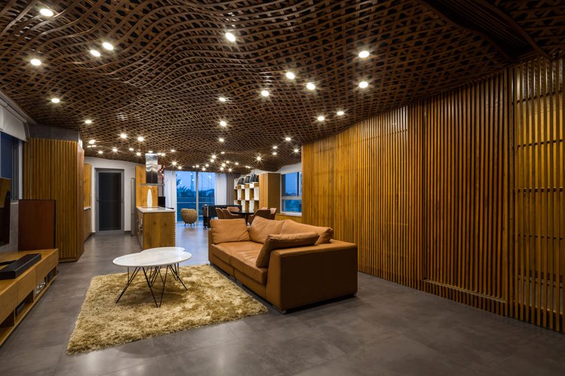 CTA tops vietnam apartment with 'cloud' of interlaced wood on its ceiling