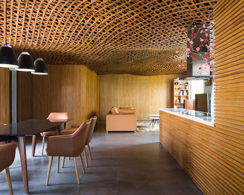 CTA tops vietnam apartment with 'cloud' of interlaced wood on its ceiling