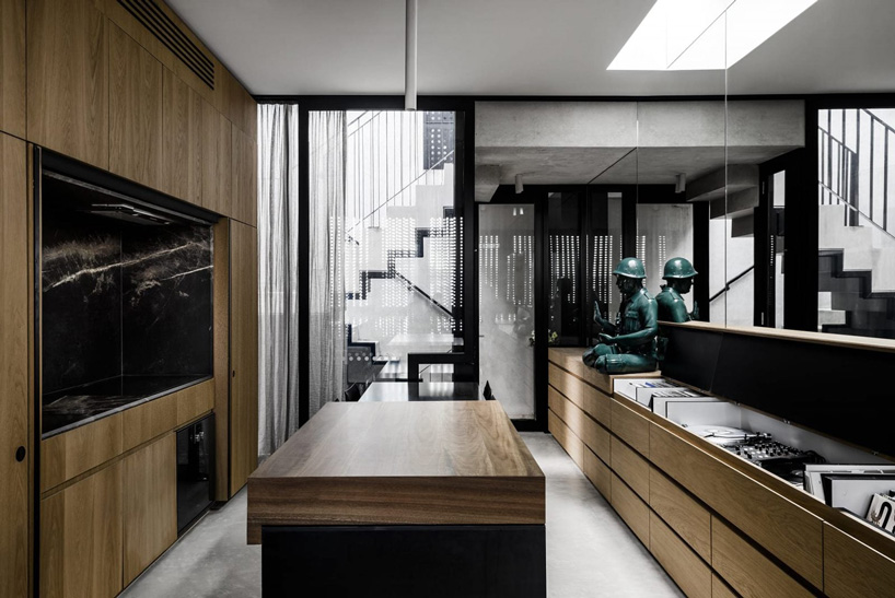 DKO architecture + SLAB architecture add black metal screen façade to vertical dwellings in australia designboom