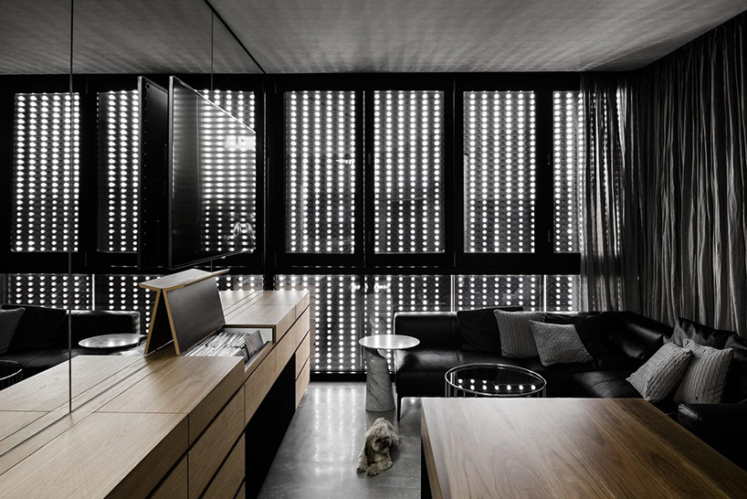 DKO architecture + SLAB architecture add black metal screen façade to vertical dwellings in australia designboom