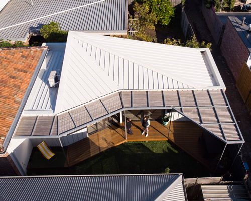 gardiner architects tops worker's cottage renovation in australia with an angled roof