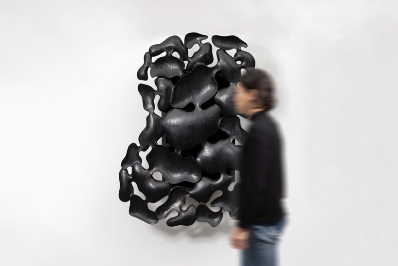 kim yun-hwan composes furniture pieces using hand-carved wooden shapes