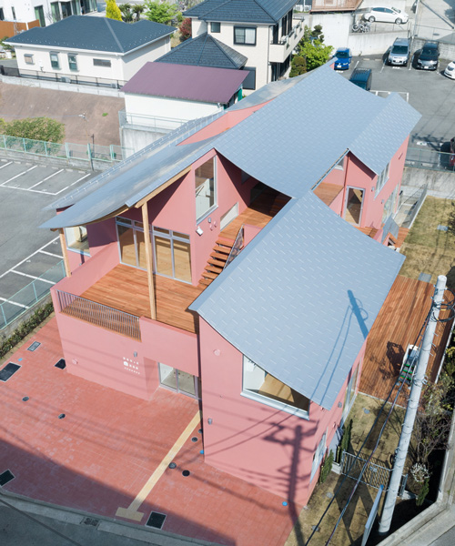 tomoyuki kurokawa tops pink-hued nursery school with a curved roof of laminated wood