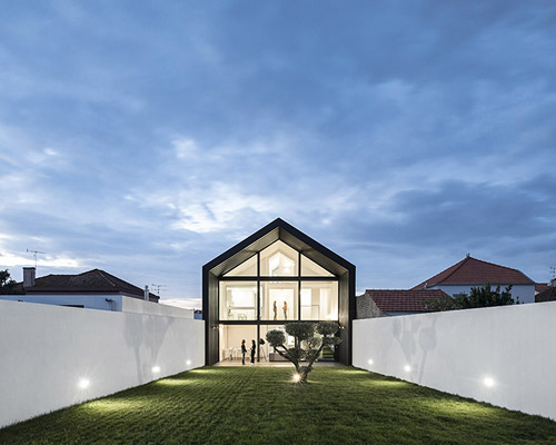 maria fradinho articulates the arch house with large gable roof in portugal