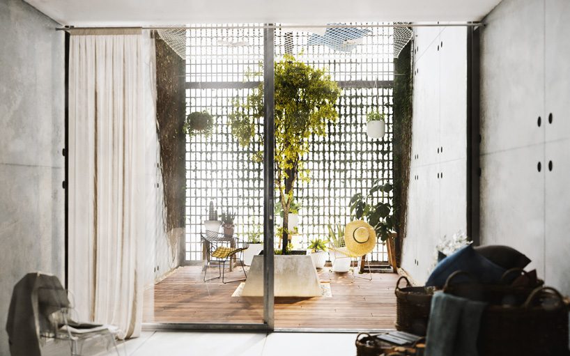 floor-to-ceiling gridded windows compose the façade of this residential complex in cyprus