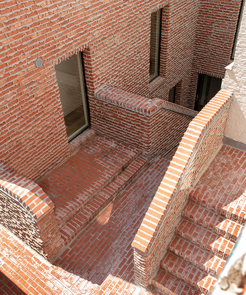 dmvA's addition to a historic site in belgium features brickwork with 'weeping mortar'