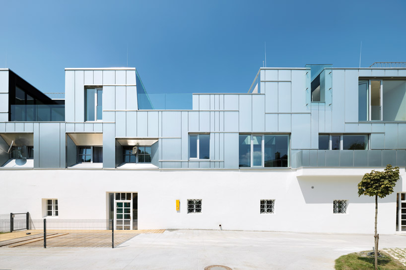 peter ebner combines metal and stucco for gestüthalle building in salzburg