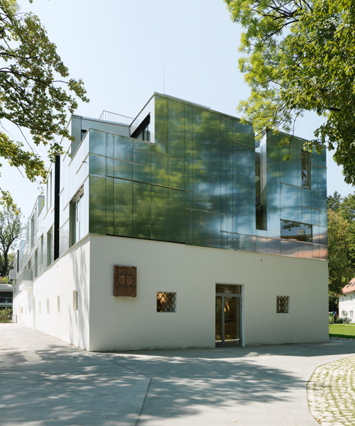 peter ebner combines metal and stucco façades for gestüthalle in salzburg