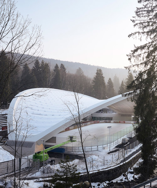 graft constructs dramatic curved roof over feuerstein arena in germany
