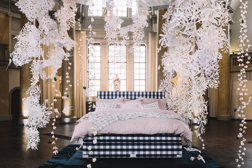  hästens unveils linen collection by lars nilsson under a sky of paper cut flowers