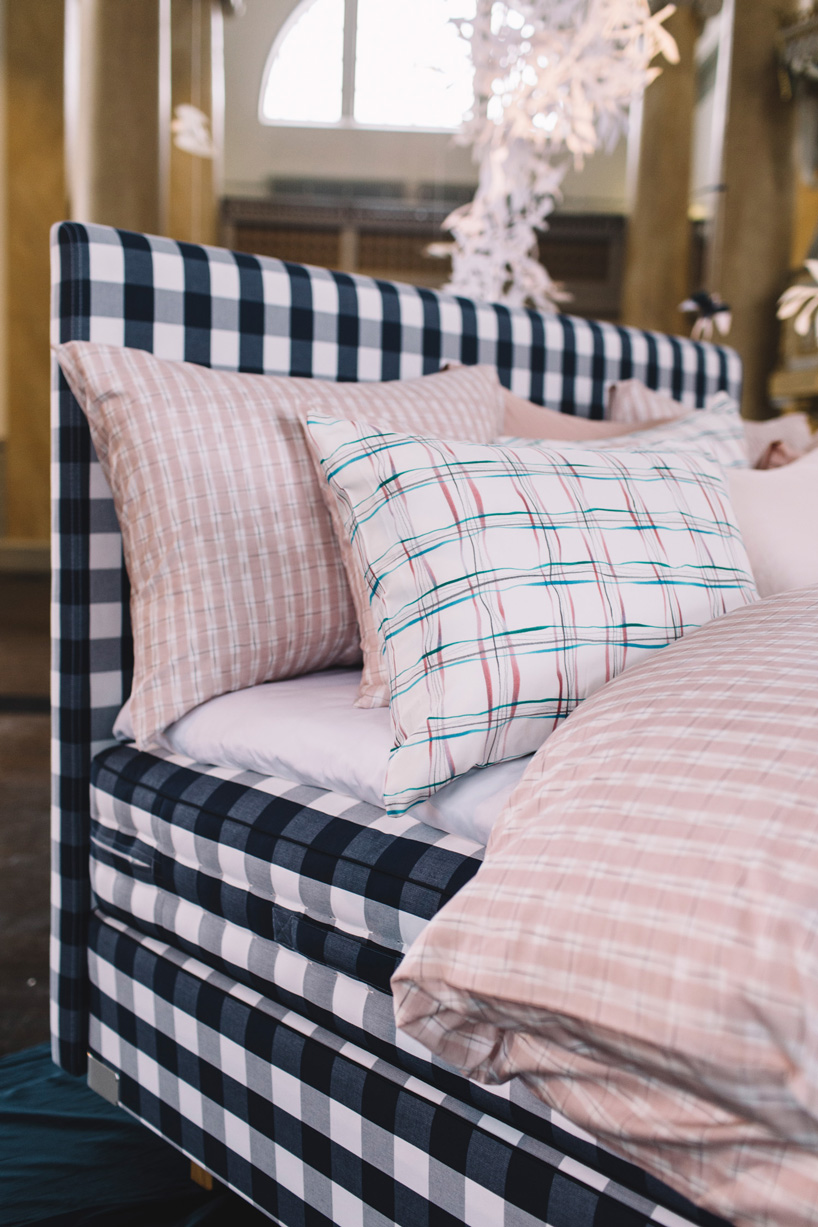 hästens unveils linen collection by lars nilsson under a sky of paper cut flowers