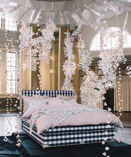 hästens unveils linen collection by lars nilsson under a sky of paper cut flowers