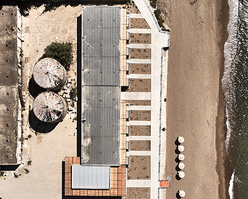k-studio transforms derelict wine factory into seaside hotel along the coast of greece