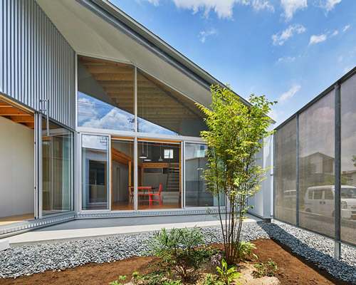 TAKiBI's 'sunlight house' in japan connects two volumes with a central courtyard