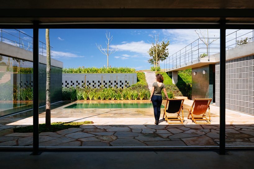 casa joão de barro by terra e tuma emerges from a sloping site in itatiba, brazil