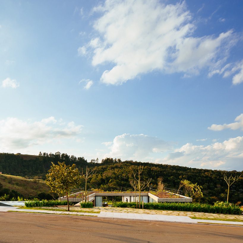  casa joão de barro by terra e tuma emerges from a sloping site in itatiba, brazil