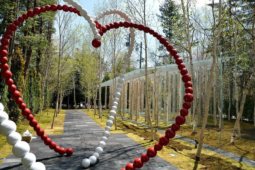 kengo kuma combines tree trunks and glass for the birch moss chapel  in japan