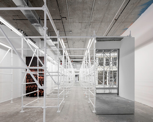 metal scaffoldings in a raw, concrete space form wardrobe.nyc new concept store in soho