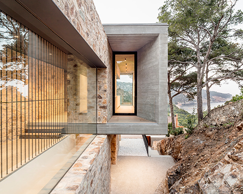 casa 1510 by nordest arquitectura emerges from the mountainous landscape of spain