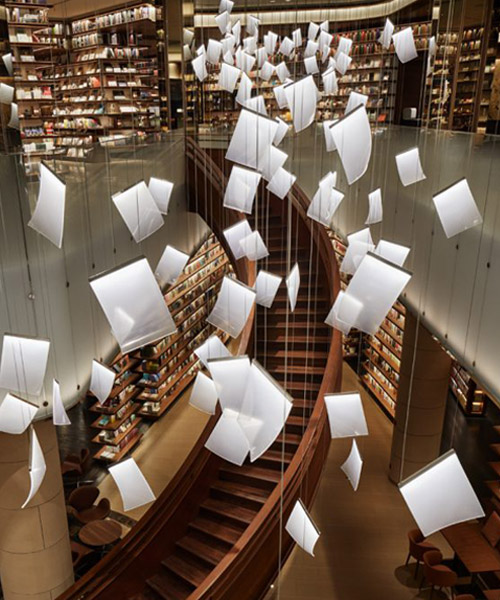 tomoko ikegai / ikg inc illuminates chinese bookstore with fluttering sheets of paper