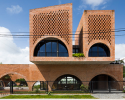 'cuckoo house' is a brick residence in vietnam that hovers above a coffee shop
