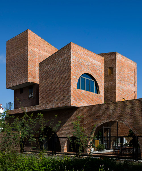 'cuckoo house' is a brick residence in vietnam that hovers above a coffee shop