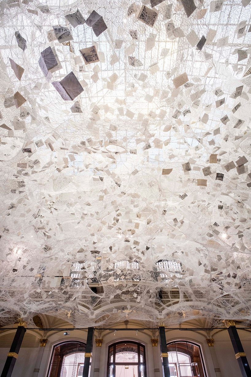 chiharu shiota weaves 'cloud of thoughts' within the atrium at gropius bau