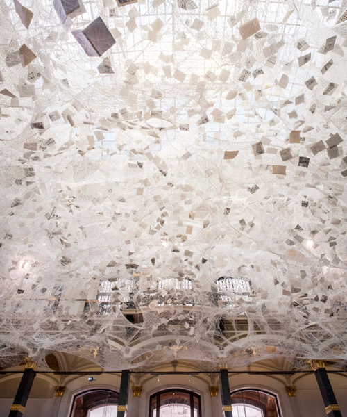 chiharu shiota weaves 'cloud of thoughts' within the atrium at gropius bau