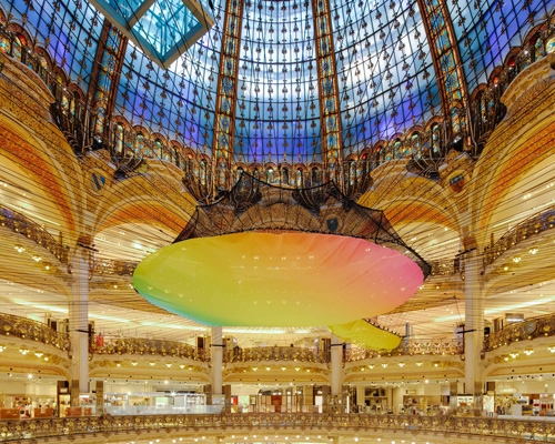 suspended rainbow playground stretches under the iconic dome of galeries lafayette in paris